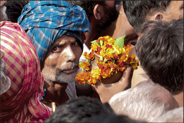 Pilgrims with jugs with water from the holy river and flowers, waiting their turn to make the offer to the Harihar Nath Tample