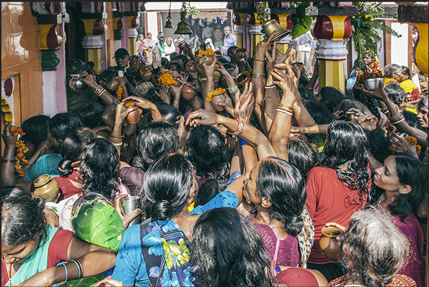 Harihar Nath temple. Pilgrims play the bell (sign of respect to the deity) and then throw the water in direction of the deity