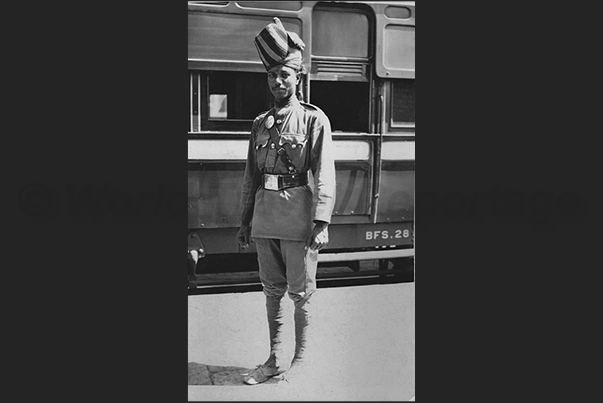 India. A policeman on duty at the train station on the line for Madras