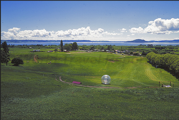 The Zorb, the transparent sphere, descends quickly to the shores of Rotorua Lake
