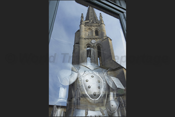 Village of Saint Emilion. Reflection of the bell tower of the monolithic church (XII) in a shop of antiquities