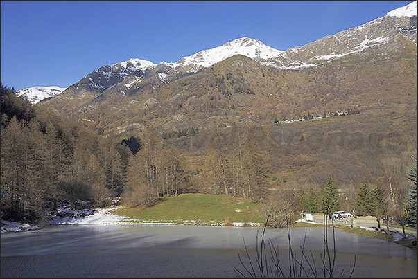 Laux Lake at the entrance to the village of Laux with the village of Usseax in front