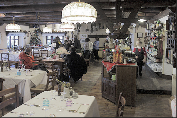 Laux Village. The hotel restaurant hall near the lake at the entrance to the village