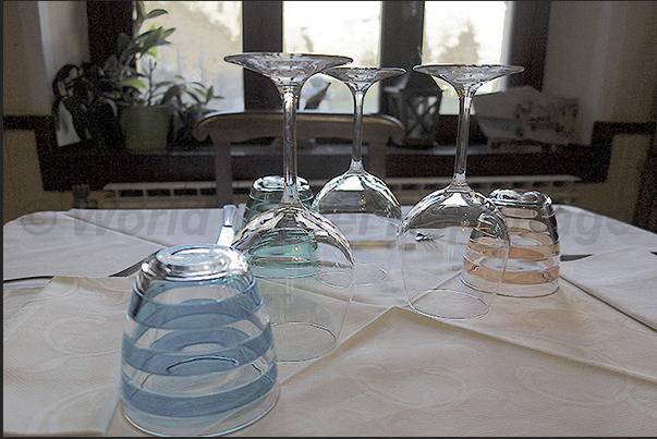 Laux Village. The hotel restaurant hall near the lake at the entrance to the village. Ready tables waiting for customers for lunch