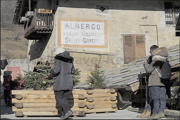 Usseaux village. People visiting the Christmas markets. The main square of the village