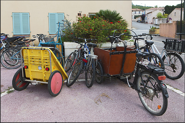 Porquerolles village rental bicycles parked in the district of the botanical garden