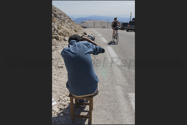 The arrival on the top of the mountain immortalized by the photographer who follows the cyclists The arrival on the top of the mountain immortalized by the photographer who follows the cyclists