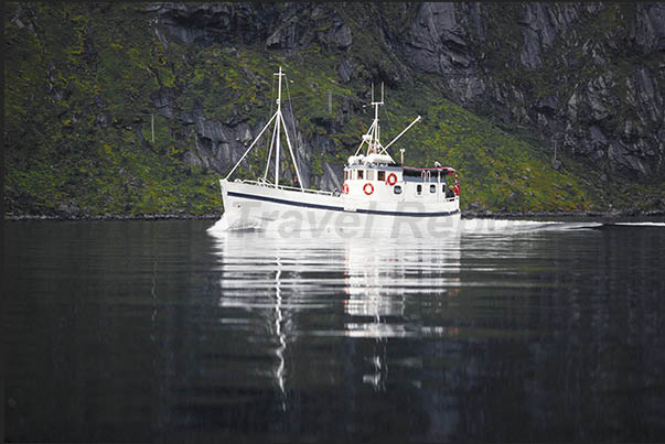 Fishingboat in the fjords upon return after a day of fishing