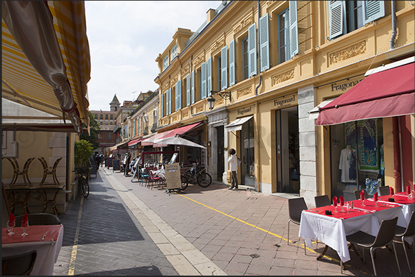 Cours Salaya with restaurants and stalls displaying flowers and handicrafts