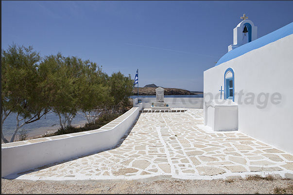 The church of Trachilos Cape in the southwest coast of Antiparos island with the island of Strongili in front