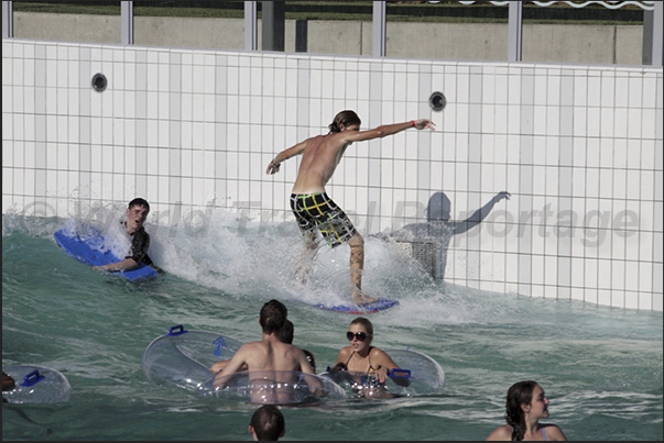 In larger pools, artificial waves are generated to be surfed