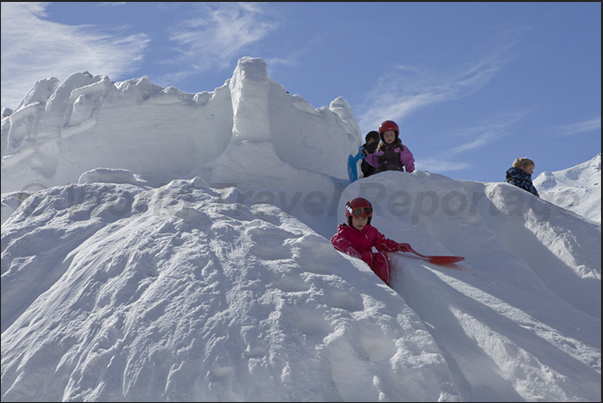 Not sand castles but snow castles for children waiting to go skiing