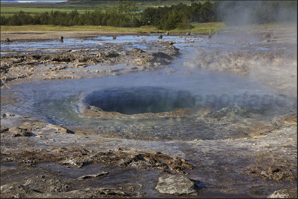Selfoss, Park of Geyser. The geyser full of water, is going to explode