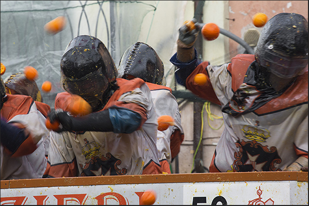 Only the guards on the chariots have the hard hats because bombarded by thousands of oranges