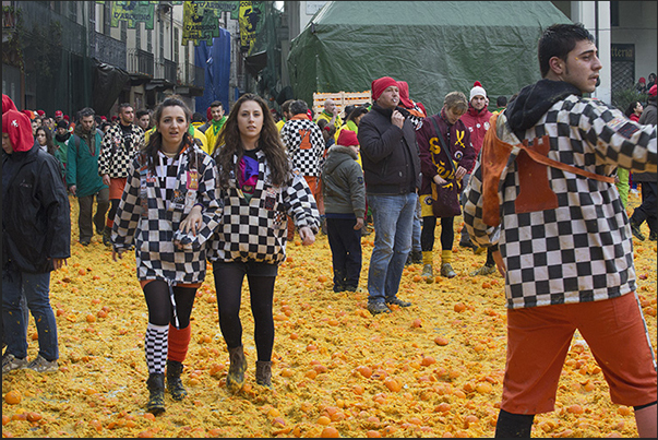 In the evening, streets and squares are covered by a layer of oranges destined to be destroyed and not eatable