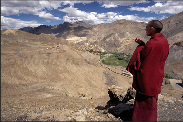 A Buddhist monk directed to the Lamayuru Monastery (visible in the background) A Buddhist monk directed to the Lamayuru Monastery (visible in the background)
