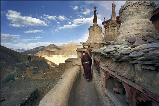 Lamayuru Monastery. A pilgrim in prayer along the path around the Sacred Stupa Lamayuru Monastery. A pilgrim in prayer along the path around the Sacred Stupa