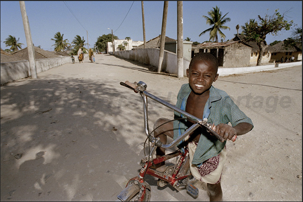 Not many children have the bicycle and the smile of this child demonstrates the joy of owning it