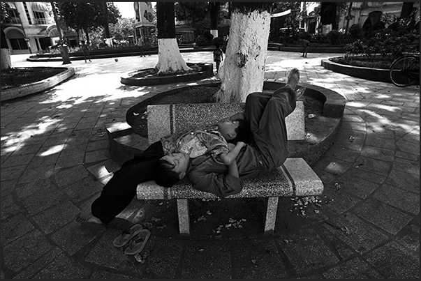 Hanoi. Afternoon nap on a bench in the public gardens